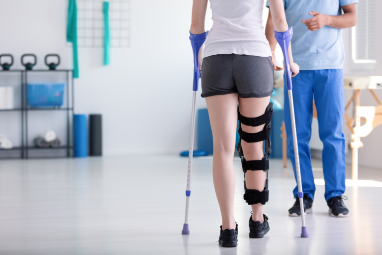 picture of a female patient on crutches as part of a post-surgical rehabilitation in Knoxville