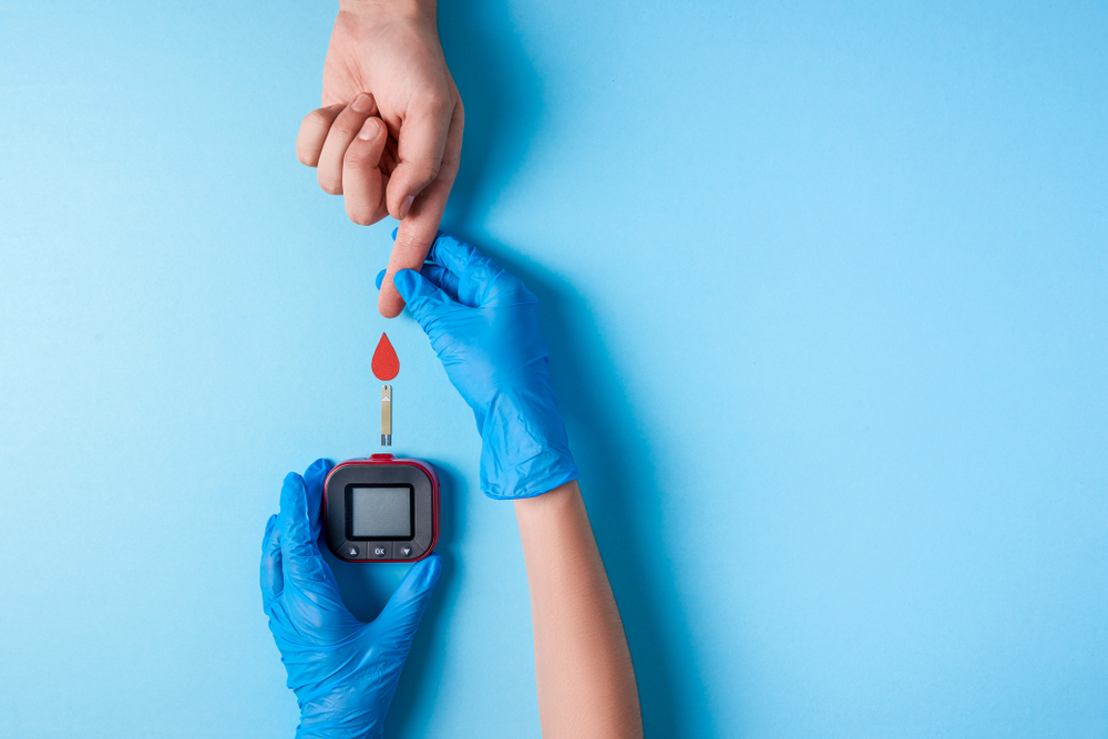 Picture of a diabetic patient taking their blood sugar